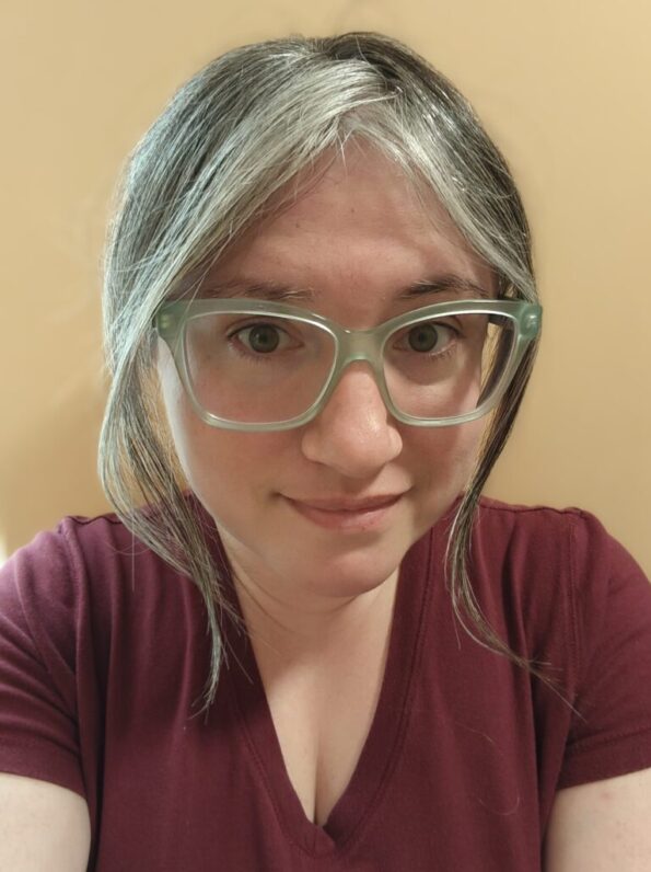A picture of Lis: a white woman with graying brown hair and light green glasses.